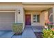 Inviting home entrance with a cozy porch, lovely landscaping, and convenient attached garage access at 5484 Mercury Springs Dr, Las Vegas, NV 89122