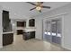 Stylish kitchen featuring dark wood cabinets, sleek countertops, stainless steel appliances, and access to the patio at 5484 Mercury Springs Dr, Las Vegas, NV 89122