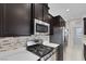 Stylish kitchen featuring stainless steel appliances and dark wood cabinets at 5484 Mercury Springs Dr, Las Vegas, NV 89122