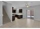 Open concept kitchen with tile floors, dark wood cabinets, and sliding glass doors to the backyard patio at 5484 Mercury Springs Dr, Las Vegas, NV 89122