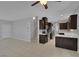 Modern kitchen featuring dark wood cabinets, sleek countertops, stainless steel appliances, and tile flooring at 5484 Mercury Springs Dr, Las Vegas, NV 89122