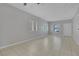 Bright living space featuring neutral tile flooring, a large window, and white walls at 5484 Mercury Springs Dr, Las Vegas, NV 89122