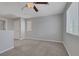 Open loft space with neutral carpet and natural light from the windows at 5484 Mercury Springs Dr, Las Vegas, NV 89122