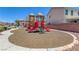 Community playground with play structure, and seating amidst lush green space at 5484 Mercury Springs Dr, Las Vegas, NV 89122