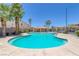 Community pool with a shallow area and mature landscaping surrounding it at 5484 Mercury Springs Dr, Las Vegas, NV 89122