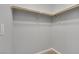 Walk-in closet space with wooden clothing rods and neutral walls at 5484 Mercury Springs Dr, Las Vegas, NV 89122