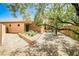 Private backyard featuring a covered patio, gravel landscaping, and shade trees at 5967 Sun Appello Ave, Las Vegas, NV 89122