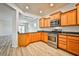 Well-equipped kitchen featuring stainless steel appliances, attractive wood cabinets, and sleek countertops at 5967 Sun Appello Ave, Las Vegas, NV 89122