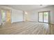 Spacious living room with plank floors and access to both the bathroom and outdoor patio at 5967 Sun Appello Ave, Las Vegas, NV 89122
