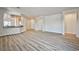 Open-concept living room with views of the kitchen, doorways to other rooms, and sliding glass doors at 5967 Sun Appello Ave, Las Vegas, NV 89122