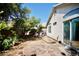 Backyard featuring a stone patio, greenery, and stucco siding on the house at 6131 Pumpkin Patch Ave, Las Vegas, NV 89142