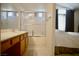 Bright bathroom featuring a vanity, mirror, and a shower-tub combination for a functional and clean experience at 6131 Pumpkin Patch Ave, Las Vegas, NV 89142