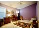 Bright bedroom featuring a purple accent wall, ceiling fan, and natural light from the window at 6131 Pumpkin Patch Ave, Las Vegas, NV 89142