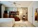 Cozy bedroom with ceiling fan, wood furnishings, and neutral-toned carpet with decorative rug at 6131 Pumpkin Patch Ave, Las Vegas, NV 89142