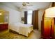Comfortable bedroom with soft lighting, a ceiling fan, and a connecting bathroom for added convenience at 6131 Pumpkin Patch Ave, Las Vegas, NV 89142