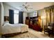 Comfortable bedroom with soft lighting, a ceiling fan, and a window that provides natural light and comfort at 6131 Pumpkin Patch Ave, Las Vegas, NV 89142