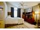 Cozy bedroom with soft lighting, a ceiling fan, and a window that provides natural light for relaxation at 6131 Pumpkin Patch Ave, Las Vegas, NV 89142