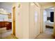 Hallway leading to a bright kitchen with modern appliances and a cozy bedroom with soft lighting at 6131 Pumpkin Patch Ave, Las Vegas, NV 89142