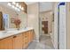Bright bathroom boasts double sinks, framed mirror, and tiled shower at 6141 Tokara Ave, Las Vegas, NV 89122