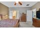 This spacious bedroom features a ceiling fan, dresser, and access to the bathroom at 6141 Tokara Ave, Las Vegas, NV 89122