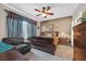 Comfortable bedroom with a ceiling fan, plush armchair, and elegant decor at 6141 Tokara Ave, Las Vegas, NV 89122
