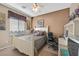 Comfortable secondary bedroom features a ceiling fan and a work space at 6141 Tokara Ave, Las Vegas, NV 89122