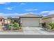 Charming single-story home featuring desert landscaping and a two-car garage at 6141 Tokara Ave, Las Vegas, NV 89122
