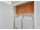 Functional laundry room with modern appliances and storage cabinets at 6141 Tokara Ave, Las Vegas, NV 89122