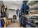 Well-organized walk-in closet with hanging clothes and shelving at 6141 Tokara Ave, Las Vegas, NV 89122