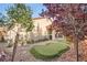Private backyard oasis with a putting green, desert landscaping, and mature shade trees at 6233 Canterbury Field Rd, Las Vegas, NV 89113