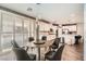 Open concept dining room to kitchen, wood floors, and lots of natural light, with stylish modern dark wood dining set at 6233 Canterbury Field Rd, Las Vegas, NV 89113