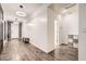 Welcoming home foyer featuring modern lighting, and stylish accent wall, and beautiful, dark wood-look flooring at 6233 Canterbury Field Rd, Las Vegas, NV 89113