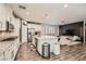Bright kitchen with white cabinets, granite countertops, stainless steel appliances, and a view to the living area at 6233 Canterbury Field Rd, Las Vegas, NV 89113