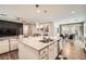 Open concept kitchen with a large island, stainless steel appliances, and a view to the living and dining areas at 6233 Canterbury Field Rd, Las Vegas, NV 89113