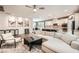 Open floor plan connecting living room to kitchen with hardwood floors and comfortable seating, perfect for entertaining at 6233 Canterbury Field Rd, Las Vegas, NV 89113
