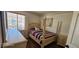 This cozy bedroom has a four-post bed, wood floors and lots of natural light at 6275 Allspice Ct, Las Vegas, NV 89142