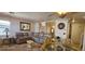 Comfortable living room with leather sectional, and round dining table and glass top at 6275 Allspice Ct, Las Vegas, NV 89142