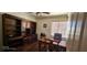 Office with wood floors, built-in shelving, and a beautiful desk at 6275 Allspice Ct, Las Vegas, NV 89142