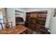 Office with wood floors, built-in shelving, and a beautiful desk at 6275 Allspice Ct, Las Vegas, NV 89142