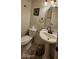 Updated powder room with pedestal sink, decorative mirror, and elegant fixtures at 6275 Allspice Ct, Las Vegas, NV 89142