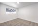 Bedroom featuring gray carpet, baseboard trim and a window at 6308 Lawton Ave, Las Vegas, NV 89107