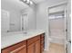 Bathroom with a large mirror, vanity with storage, and a shower-tub combination at 6678 Crystal Run Ln, Las Vegas, NV 89122
