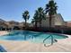 Community pool surrounded by palm trees, offering a relaxing and resort-like experience at 6678 Crystal Run Ln, Las Vegas, NV 89122