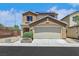 Two-story home featuring a two car garage, neutral color palette and solar panels at 6678 Crystal Run Ln, Las Vegas, NV 89122