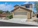 Exterior view of a two-story home featuring solar panels and a two car garage at 6678 Crystal Run Ln, Las Vegas, NV 89122