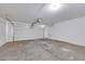 Spacious two car garage with a white door and concrete floors, offering ample parking and storage at 6678 Crystal Run Ln, Las Vegas, NV 89122