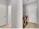 Functional laundry room with washer, dryer, and storage shelves at 6678 Crystal Run Ln, Las Vegas, NV 89122