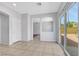 Open-concept living area with tiled floors, neutral tones, and an arched doorway at 6678 Crystal Run Ln, Las Vegas, NV 89122