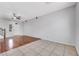 Open living room with hardwood and tile floors, ceiling fan and front door at 6678 Crystal Run Ln, Las Vegas, NV 89122