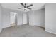 Large primary bedroom with adjacent bathroom, ceiling fan, and carpet flooring at 6678 Crystal Run Ln, Las Vegas, NV 89122